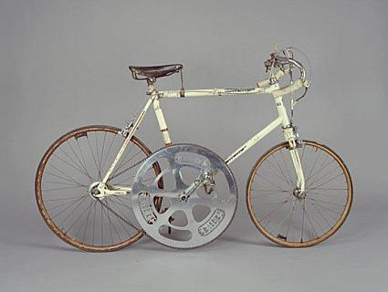 A cream-colored bike with a huge chain ring.