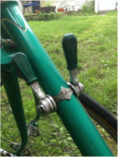 The green bicycle has matching shift levers.